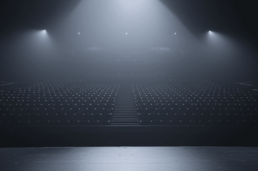 Empty concert seats in a darkened venue, suggesting concert venue punishment.