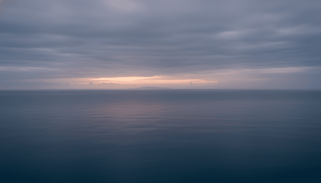 A cloudy, atmospheric sunrise over the Florida Straits, with faint outlines of a distant coastline, symbolizing the uncertainty as the Trump team readies Cuba crisis response.